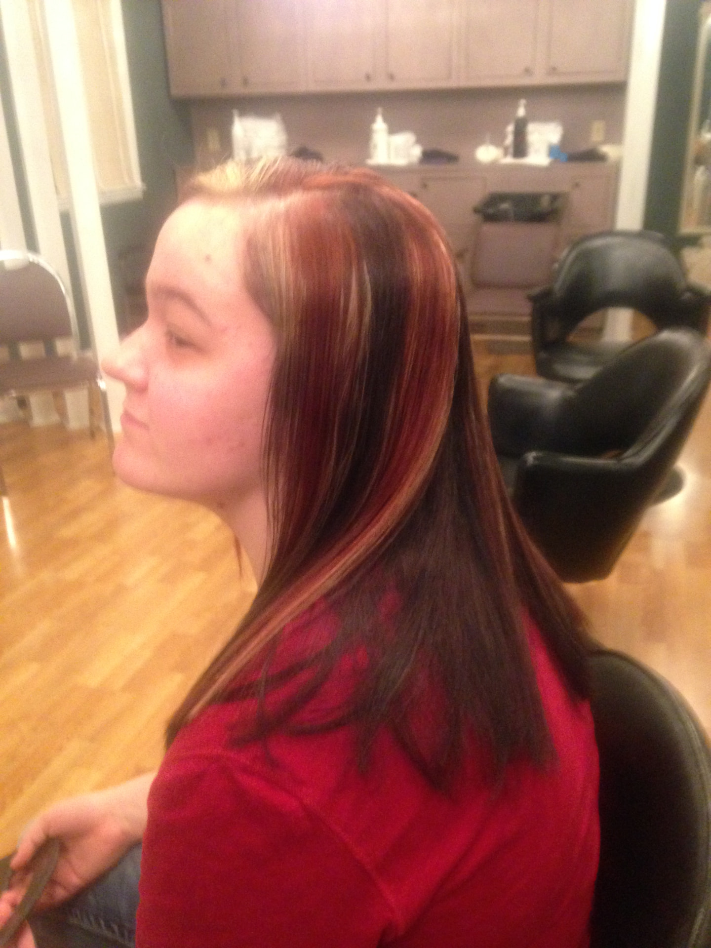 Red and blonde highlighted color on long straight hair